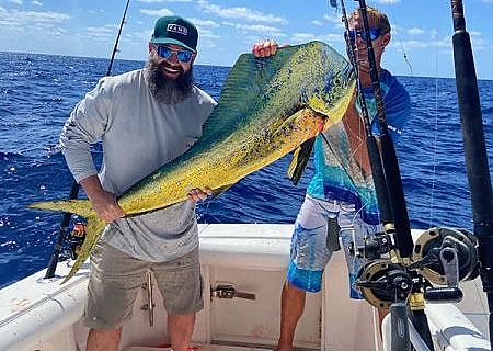 two men pose with large fish