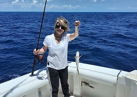 Woman holding up her catch