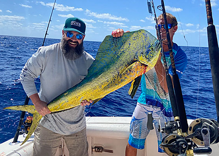 Two men hold up catch on deep fishing trip